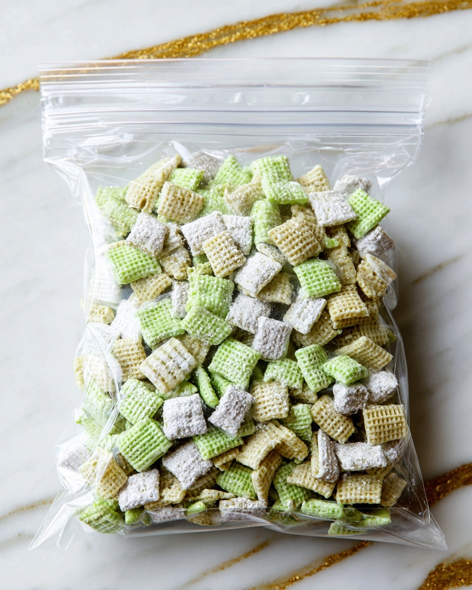 A clear plastic ziplock bag is full of small square cereal pieces with a waffle-like texture that are light green in color. Some cereal pieces are coated on one side with a light green glaze and sprinkled with white powdered sugar, giving a soft textured look. The bag sits on a white marbled surface with some gold streaks showing in the background. The cereal pieces inside the bag are layered unevenly, filling the whole bag. photo taken with an iphone --ar 4:5 --v 7