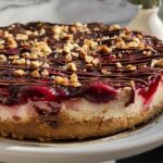 Cherry Blossom Cheesecake with Cherry Pie Filling, Chocolate Drizzle, and Crunchy Nuts Recipe