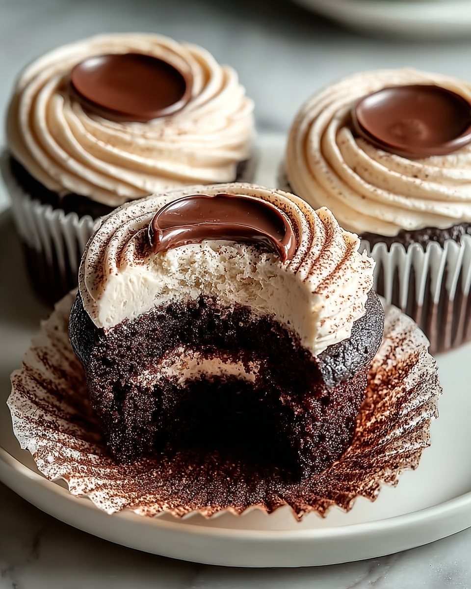 Three large chocolate cupcakes arranged together on a pristine white square serving platter with gold trim, each cupcake topped with rich, smooth chocolate ganache in the center and surrounded by perfectly swirled, creamy light mocha frosting dusted with cocoa powder, the full set captured in a professional 3/4 angle shot on a white marble kitchen countertop with natural soft directional daylight highlighting the indulgent texture and detail, styled with elegant simplicity for a luxurious gourmet food magazine hero image. REALISTIC STYLE IMAGE| TAGS: High-end food photography, clean composition, dramatic lighting, luxurious, elegant, mouth-watering, indulgent, gourmet | CAMERA: Nikon Z7 | FOCAL LENGTH: 50mm | SHOT TYPE: Close-up | COMPOSITION: 3/4 angle | LIGHTING: Soft directional light | PRODUCTION: Food Stylist | TIME: Daytime I LOCATION TYPE: Kitchen near windows --stylize 150 --ar 4:5